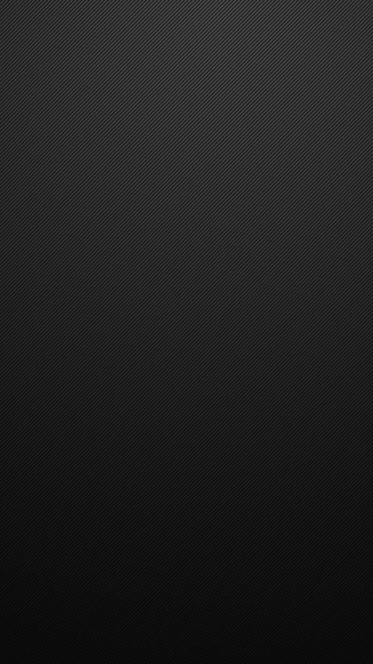 Fine matte grain covers the whole screen, lightest around the upper half and settling darker toward the bottom edge where the dock sits.