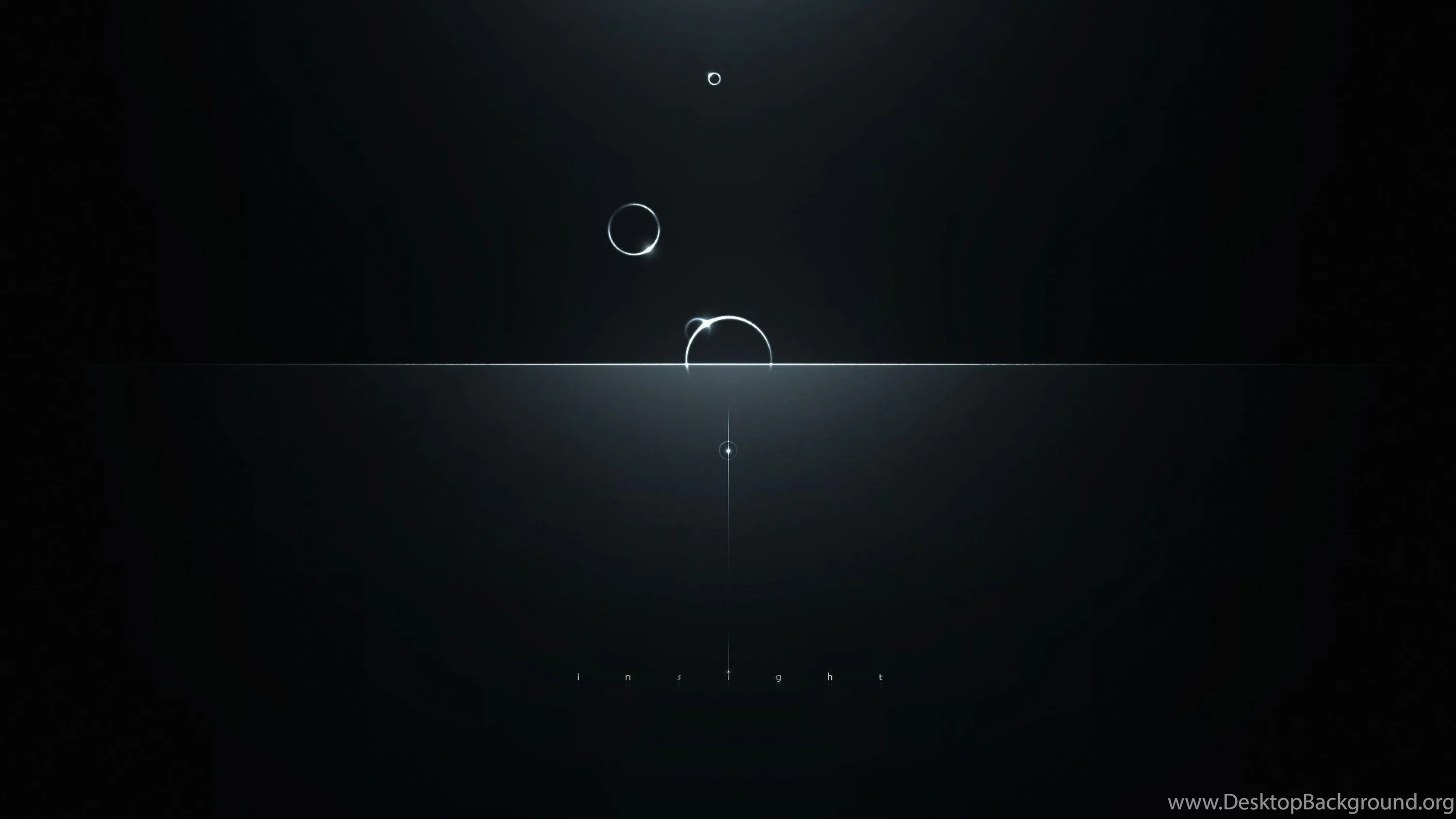 Three small bubbles drift upward through near-black water, a thin line of light marking the surface below them.