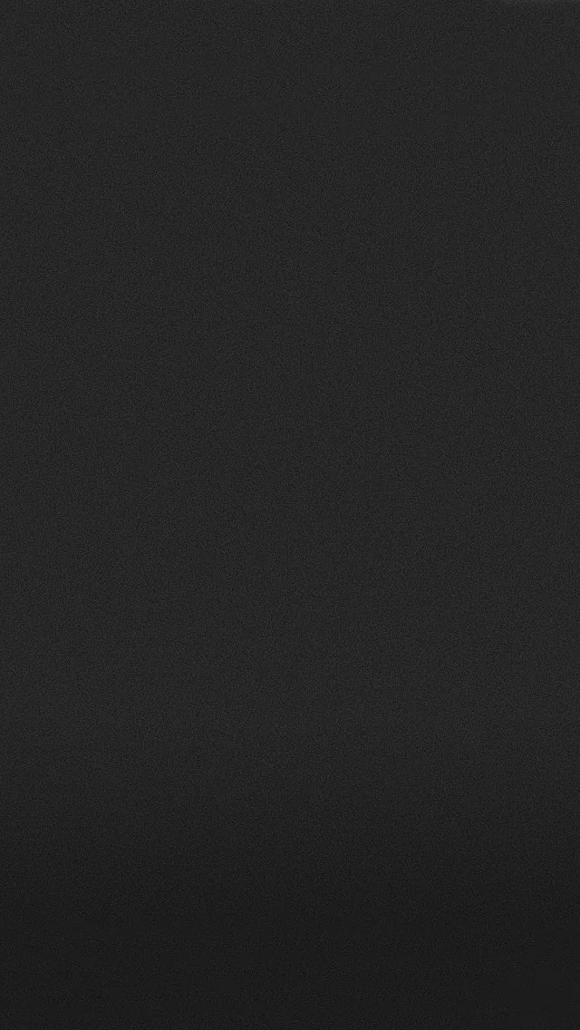 One flat matte charcoal tone with the faintest lift toward the top, nothing in it to compete with app icons or a lock screen clock.