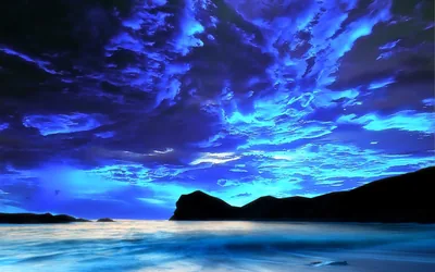 Torn Blue Clouds Over a Dark Coast HD Wallpaper