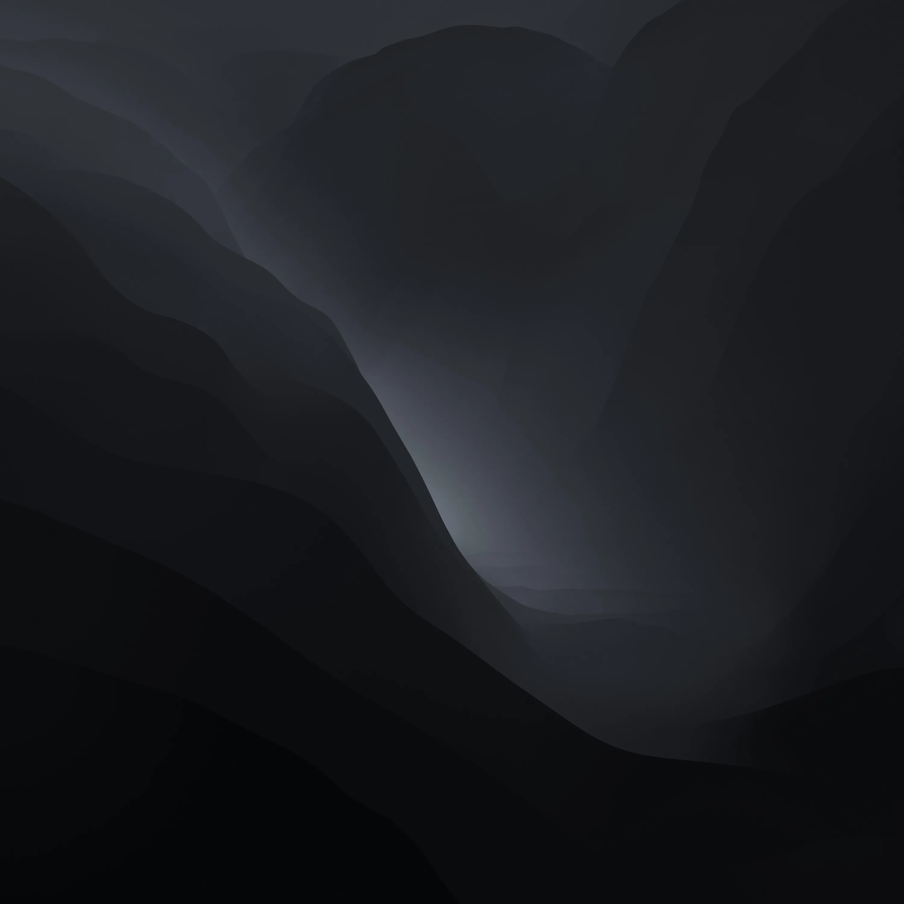 Layered ridgelines fade into fog down a narrow valley, painted in greys so muted the foreground slopes read as pure shadow.