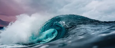 Curling Wave Against a Stormy Sky HD Wallpaper