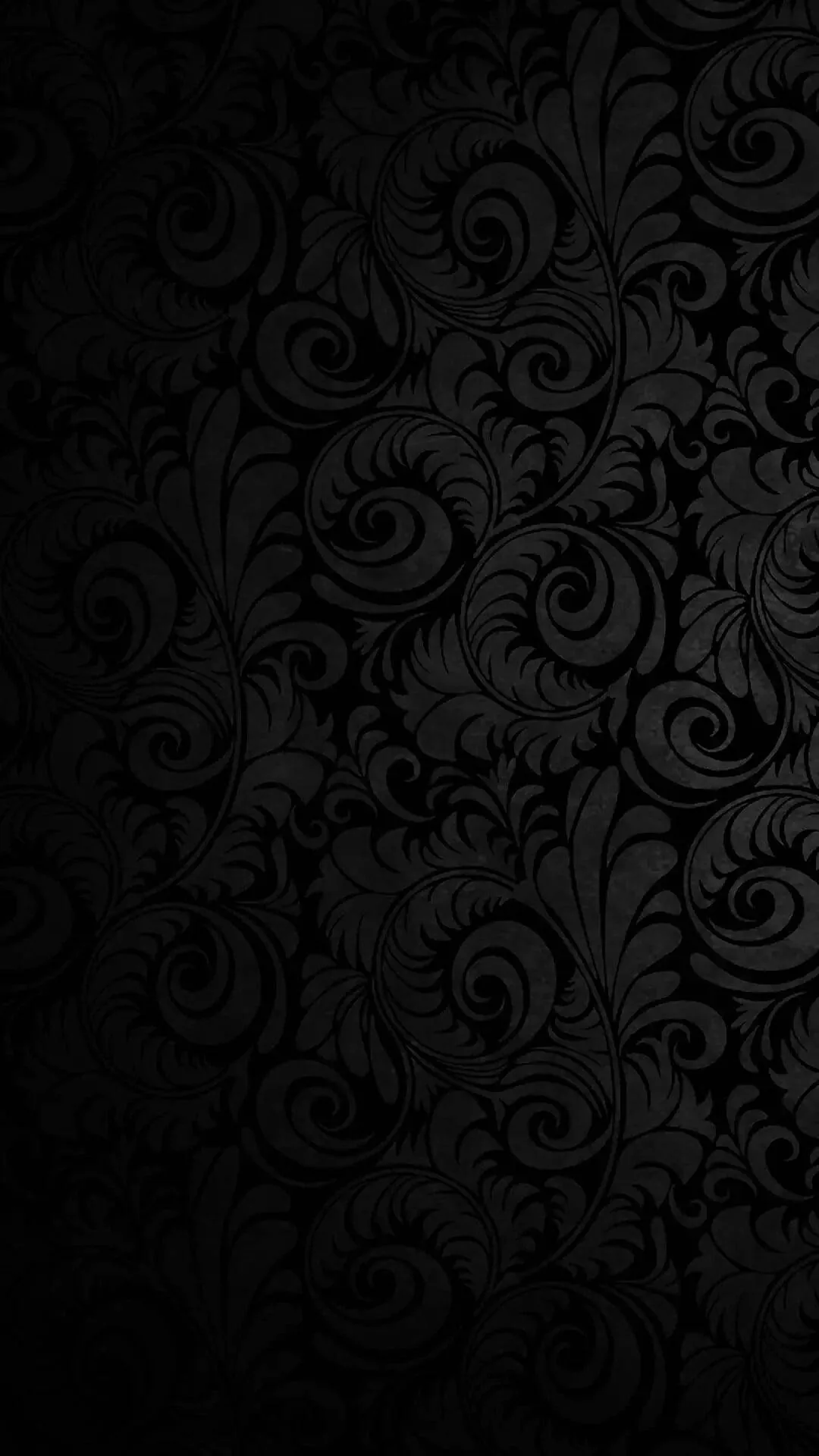 Baroque scrollwork covers the whole surface but barely a shade above the background, brightest along the top edge and sinking to true black below.