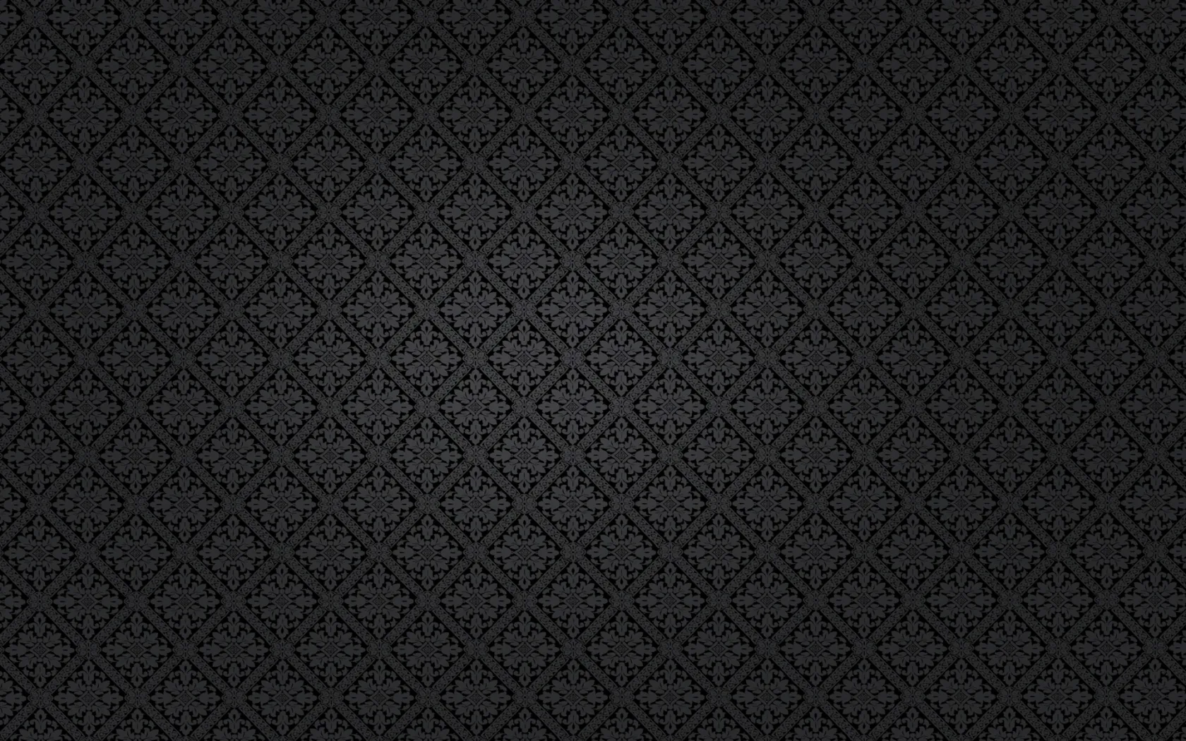 A small diamond motif repeats edge to edge over near-black cloth, brightest through the middle and sinking to black at the corners.