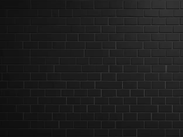 Small black bricks laid in tight even rows, a gentle wash of light along the top edge fading out before it reaches the lower corners.