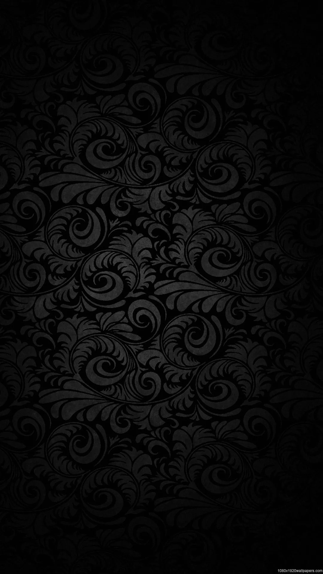 Swirling paisley shapes fill the tall frame in near-black tones, the pattern strongest through the middle.