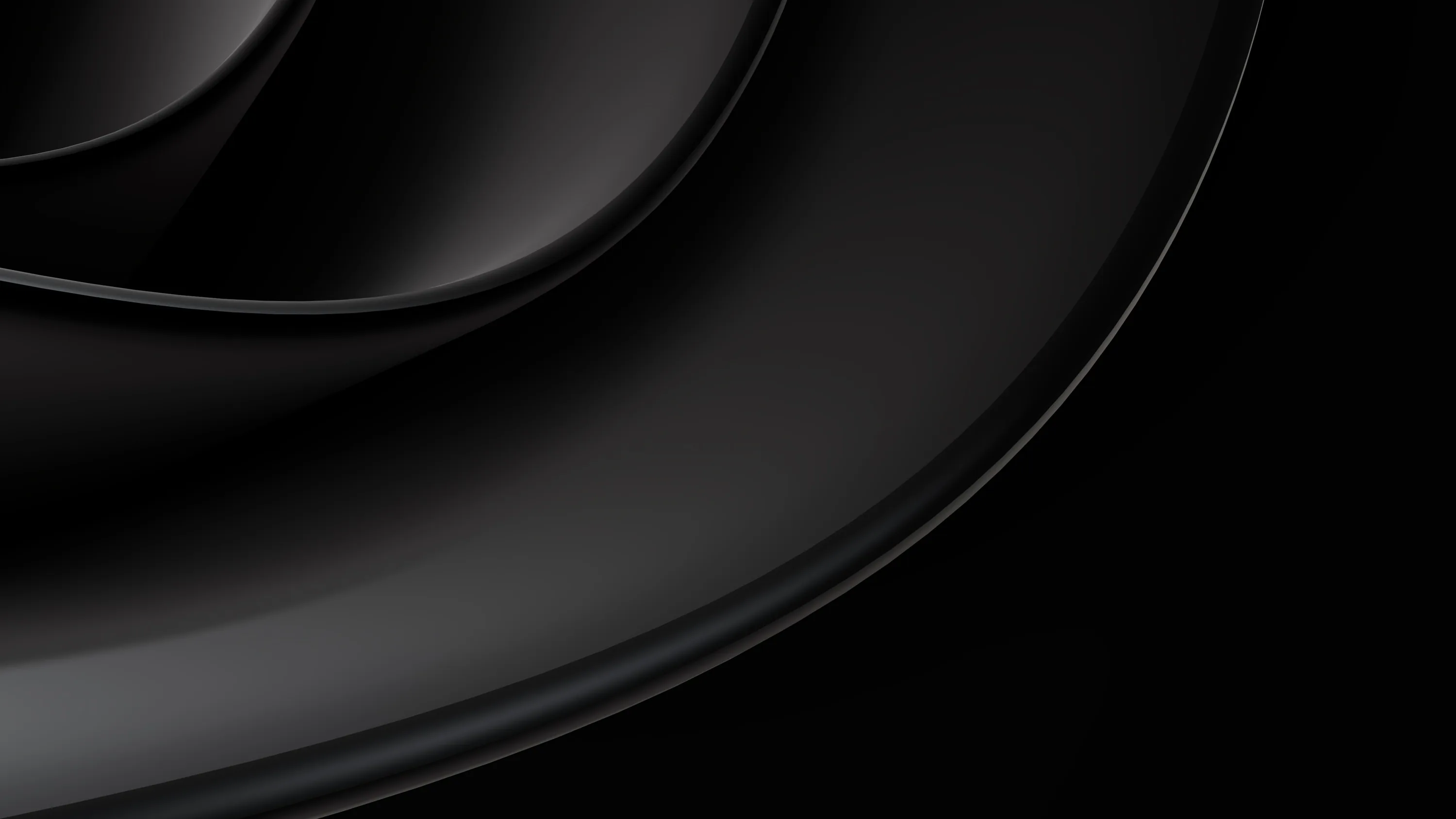 A smooth dark ridge sweeps in from the left corner, its edge catching light while the right half stays black.