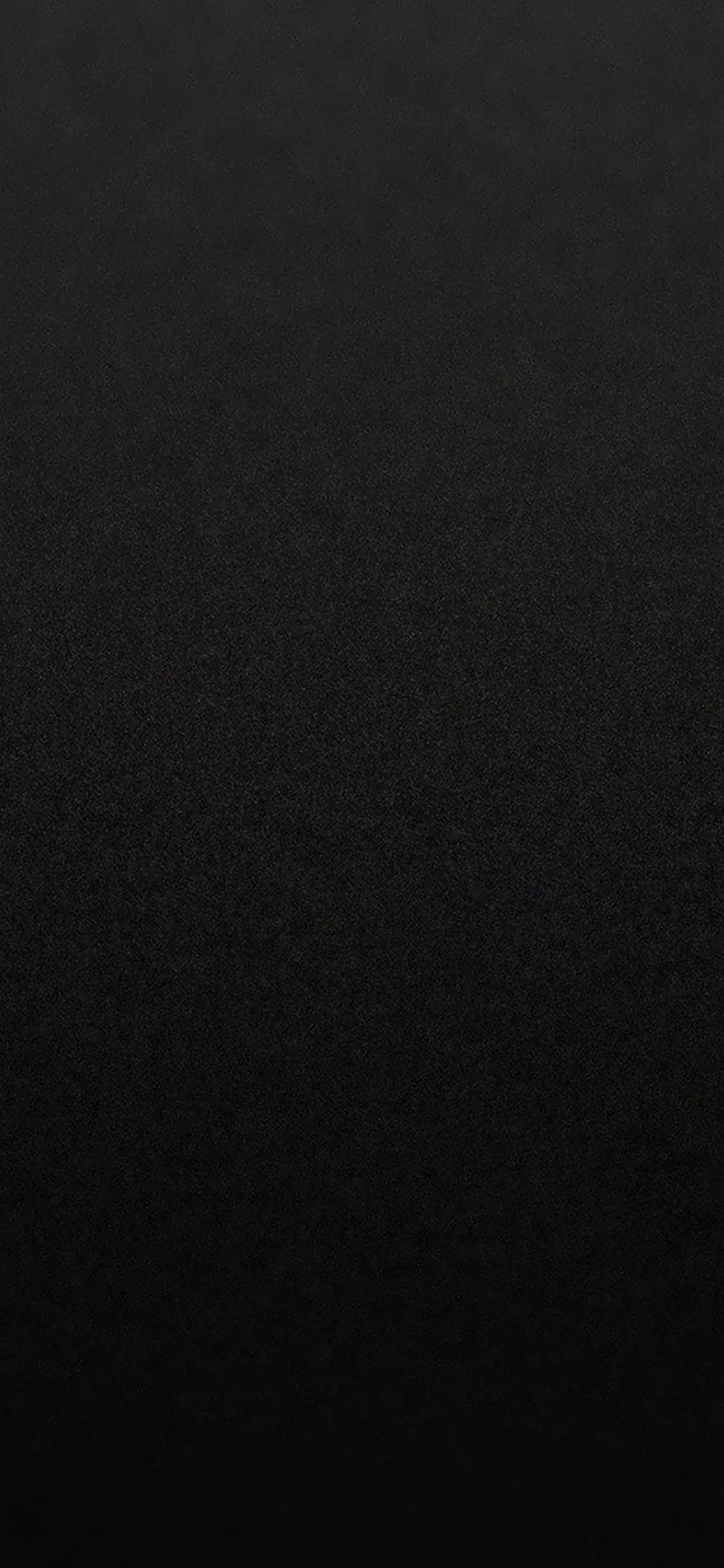 Nothing but an even, softly grained near-black field edge to edge, giving app icons and notification text maximum contrast wherever they land.