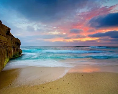 Sandstone Cliff Beside Pastel Surf HD Wallpaper