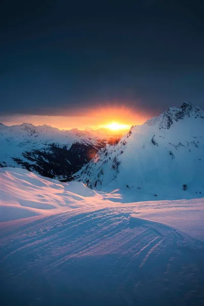 Low Sun Over a Windswept Snowfield HD Phone Wallpaper