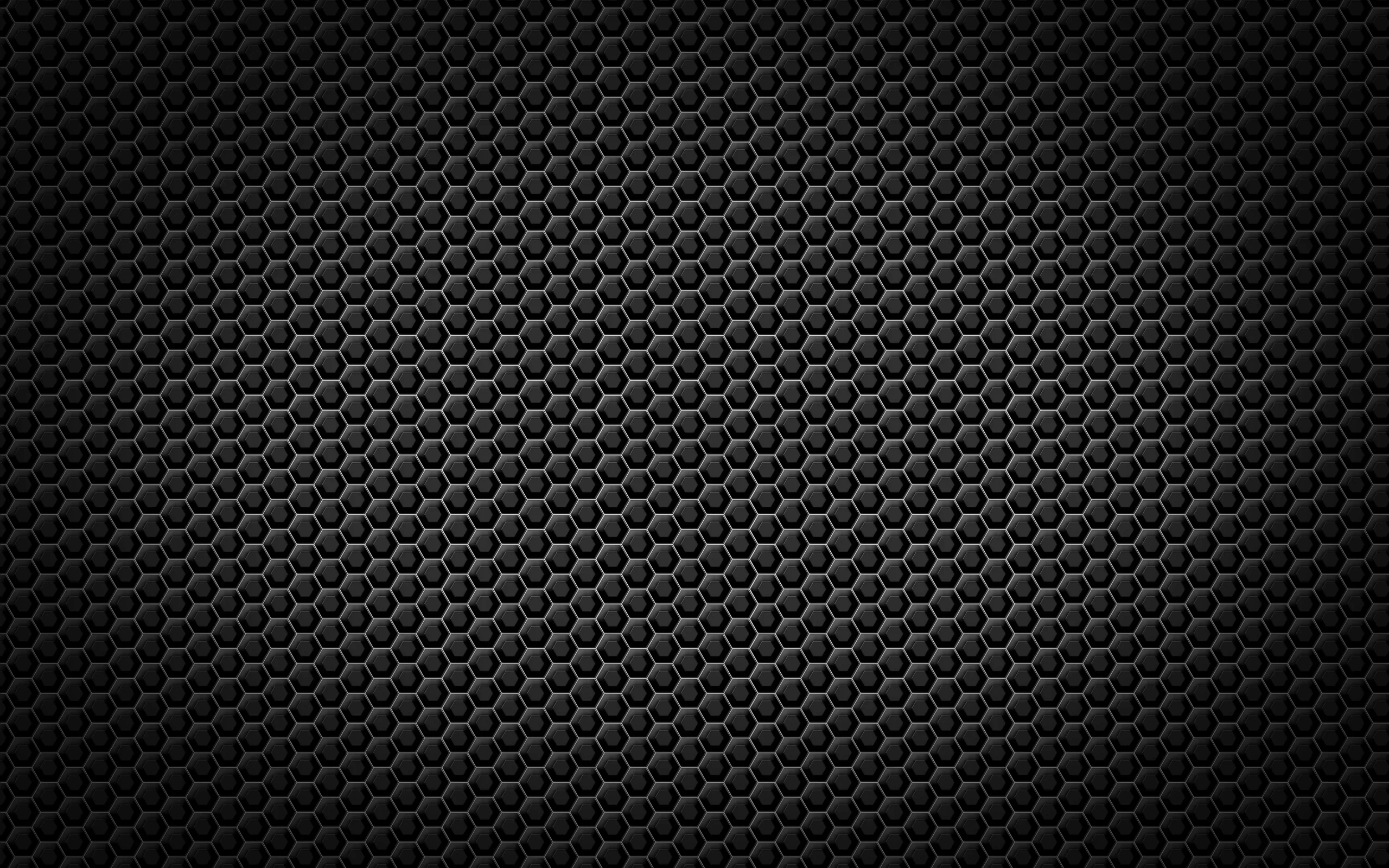 Bevelled hexagon cells repeat in tight rows across the frame, evenly lit through the middle band and dimming gently toward all four corners.