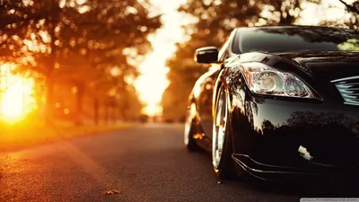 Black Sedan Front Low Angle at Sunset HD Wallpaper