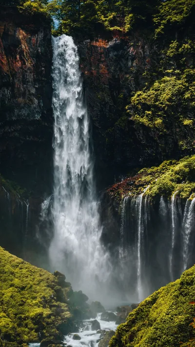 Tall Waterfall Over a Mossy Cliff HD Phone Wallpaper