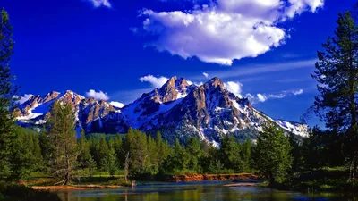Craggy Peaks Above a Forest River HD Wallpaper