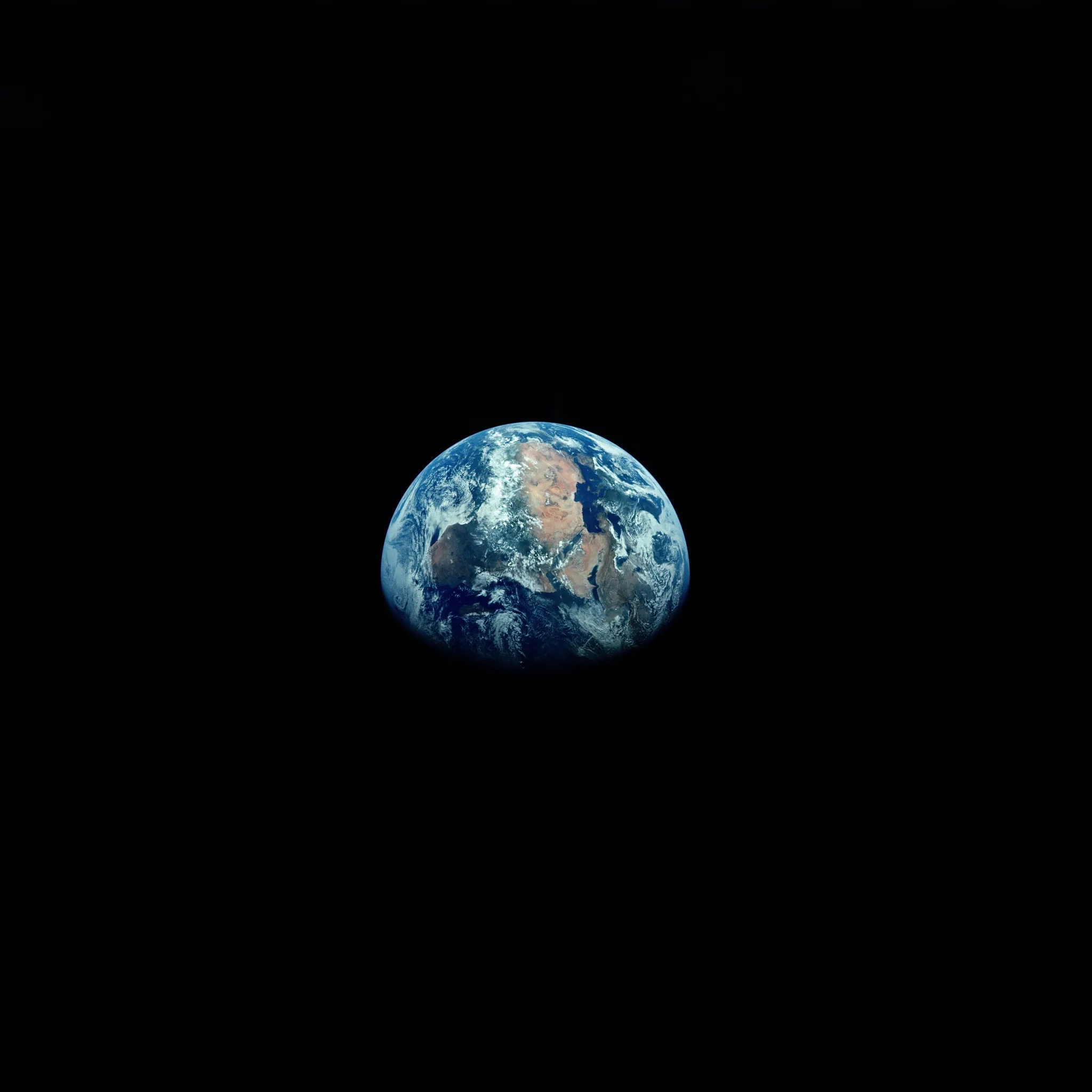 A small gibbous Earth floats just above centre in a sea of true black, most of the square frame left empty for AMOLED displays.