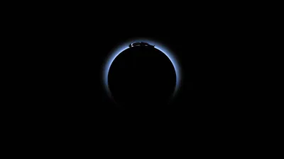 Figure Atop an Eclipsed Planet HD Wallpaper