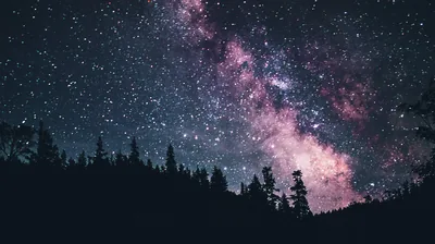 Hazy Pink Galaxy Over a Forest Ridge HD Wallpaper