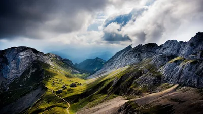 Dark Clouds Gathering Over a Grassy Pass HD Wallpaper