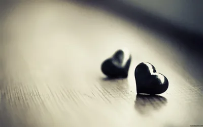 Two Dark Hearts on a Pale Wooden Table HD Wallpaper