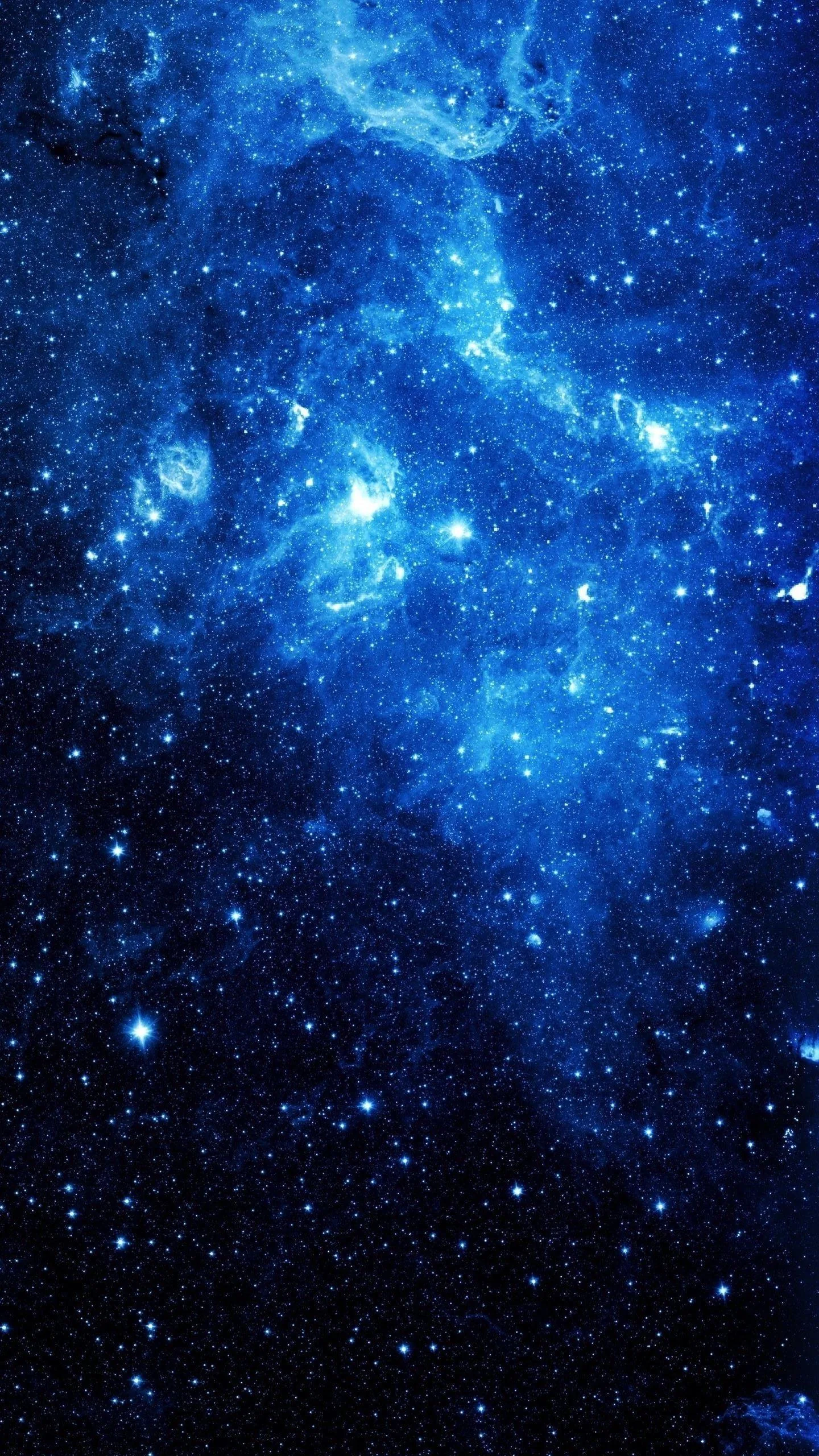 A bright nebula burns through the upper half of a dense blue star field, the glow thinning so the lower corners keep their darkness.