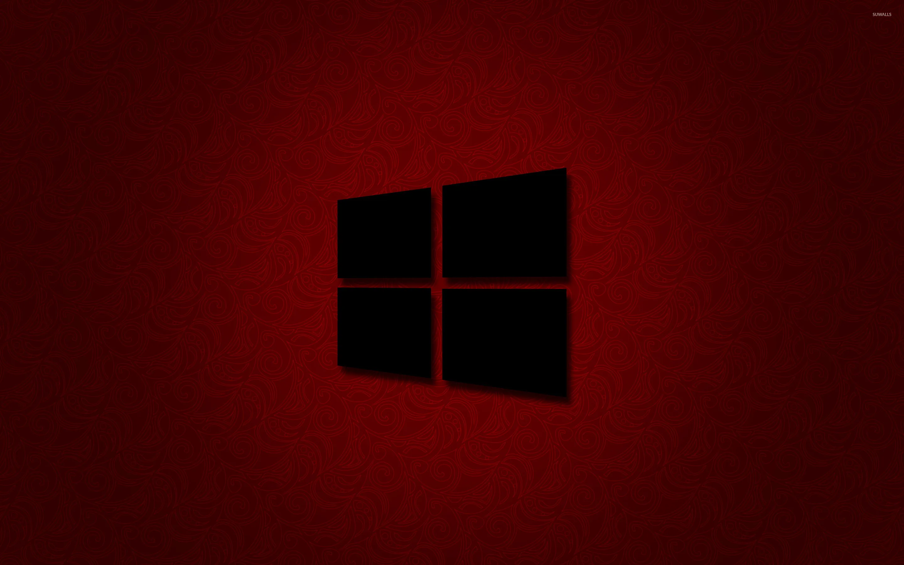 The four-pane mark sits cut out in black at the centre of a deep red field that darkens at the corners.