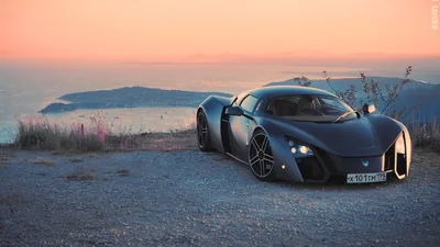 Black Supercar on a Coastal Cliff at Sunset HD Wallpaper