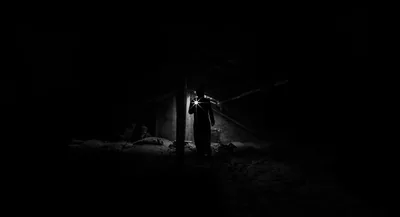 Lone Figure in a Lit Doorway HD Wallpaper