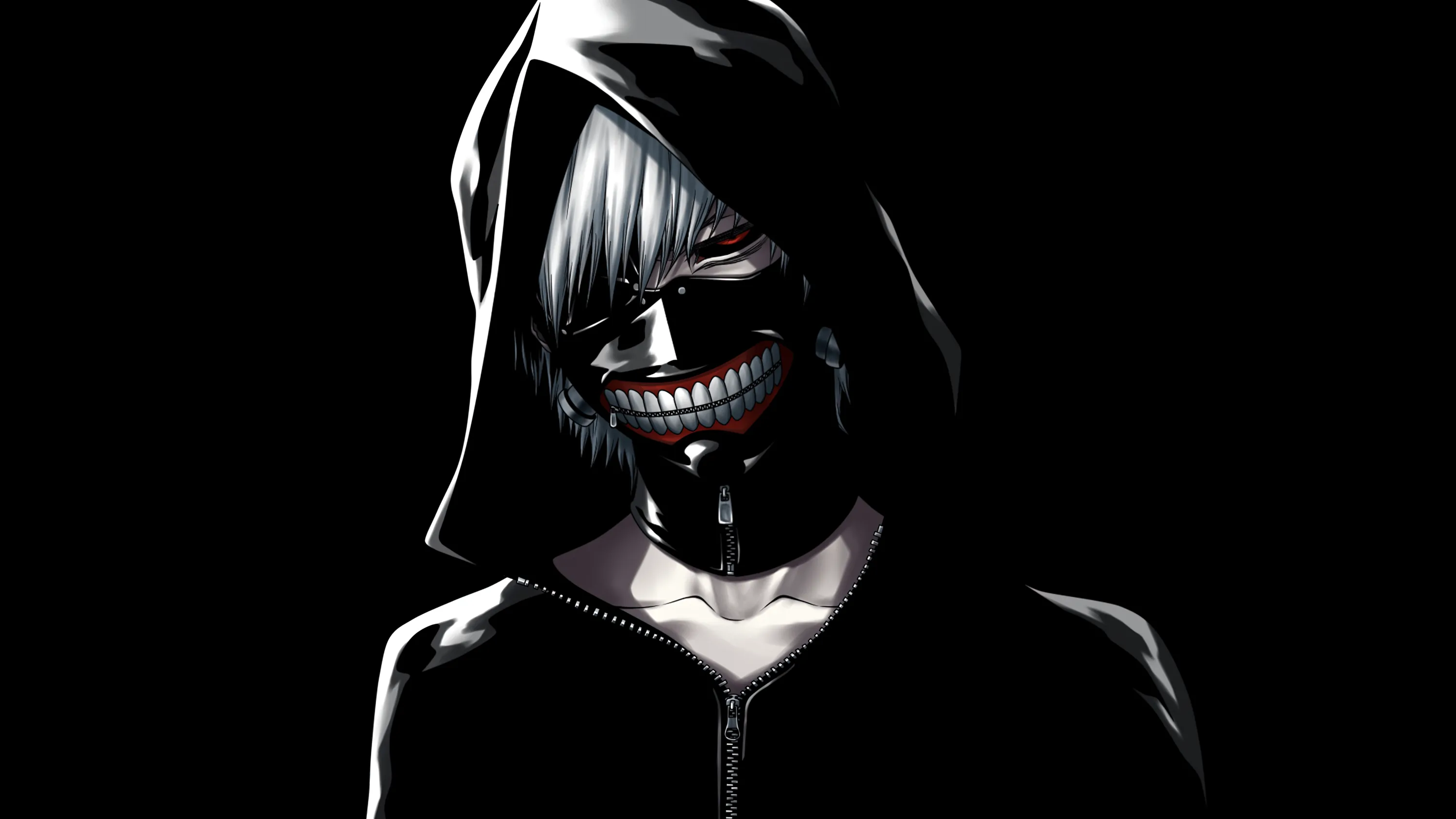 A hooded figure grins through a zippered ghoul mask, one red eye showing, his black jacket merging into the black behind him.