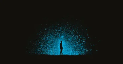 Blue Particle Burst Around a Silhouette HD Wallpaper