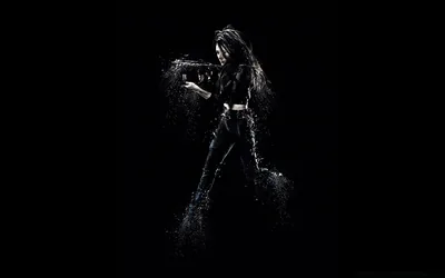 a girl in black on a dark background