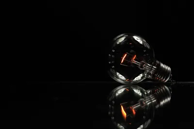 Incandescent Bulb on a Black Table HD Wallpaper