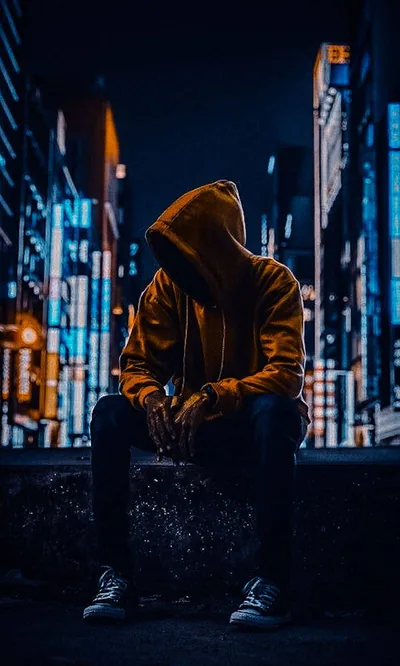 Boy Sitting Alone on a City Ledge HD Phone Wallpaper