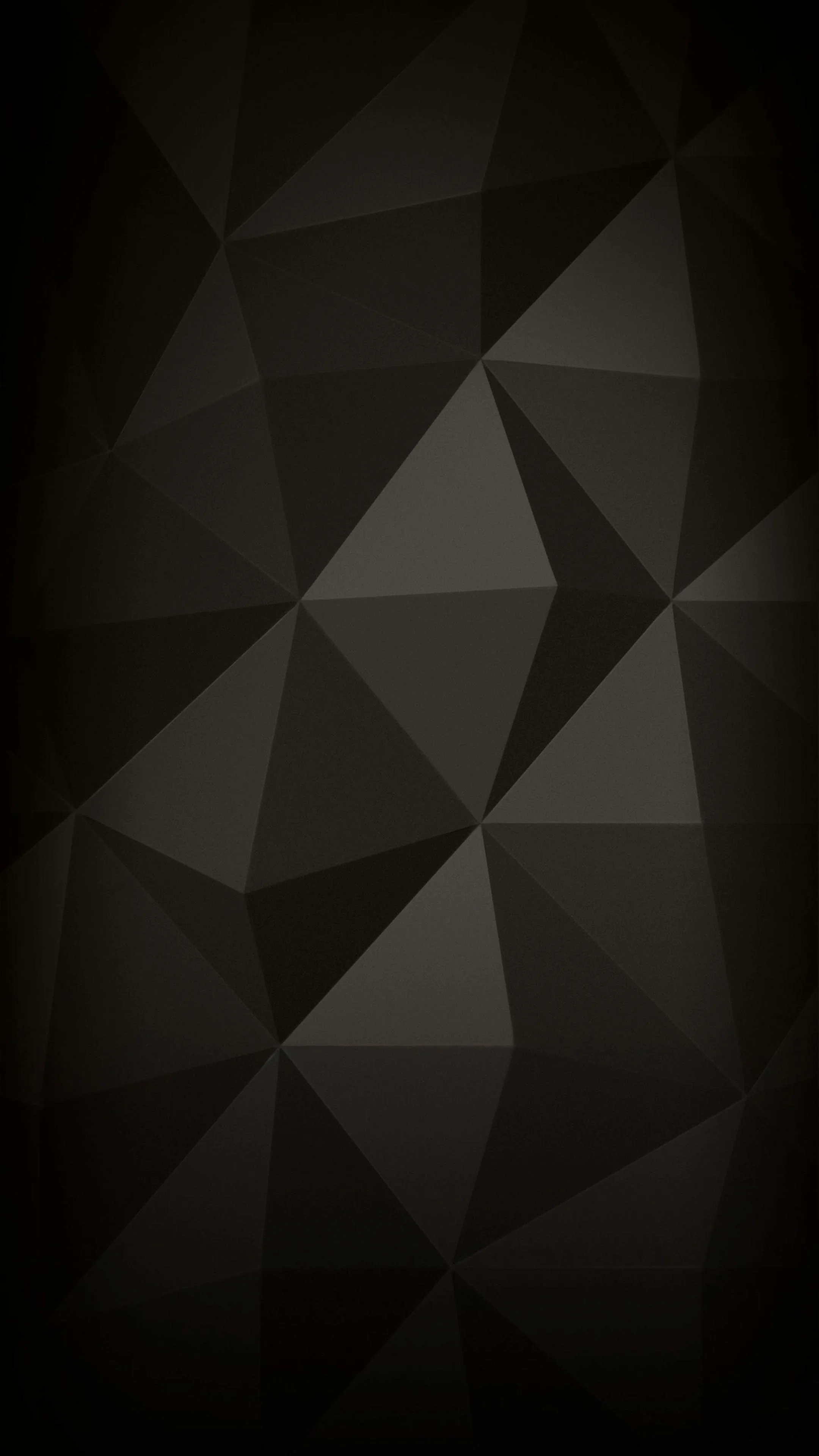Flat triangular facets tile the whole frame in shades of dark grey and brown, each panel a slightly different tone so the surface reads like folded paper.