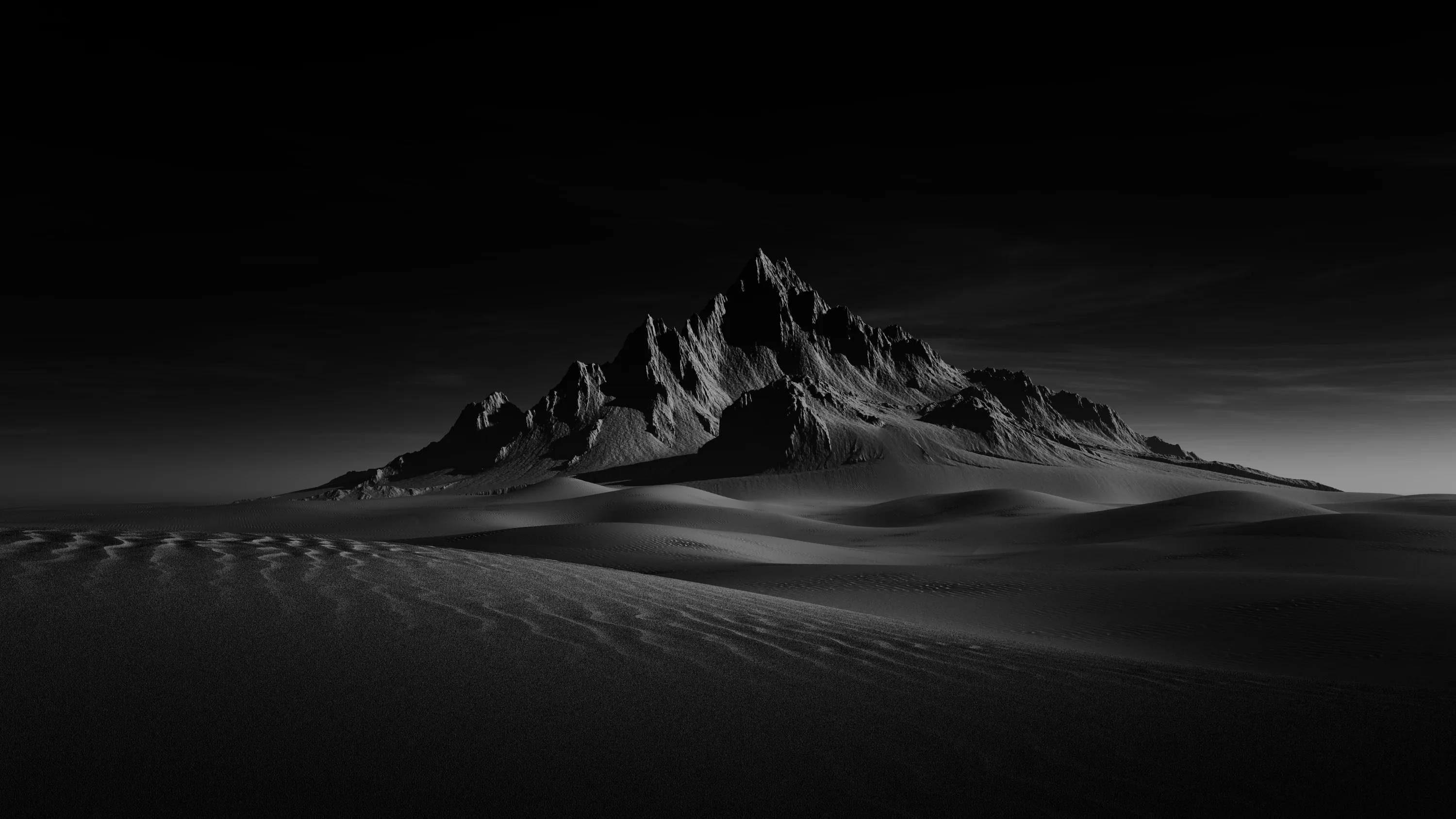 A sharp rock summit rises from rippled black sand, side light picking out the ridges while the sky stays near black.