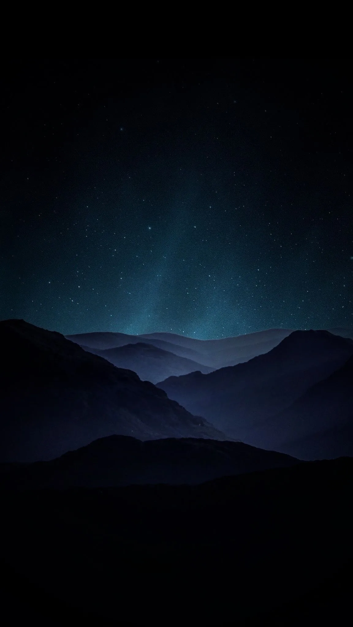 Faint green light spreads above a range of blue-black ridges, stars scattered thin across the upper sky.