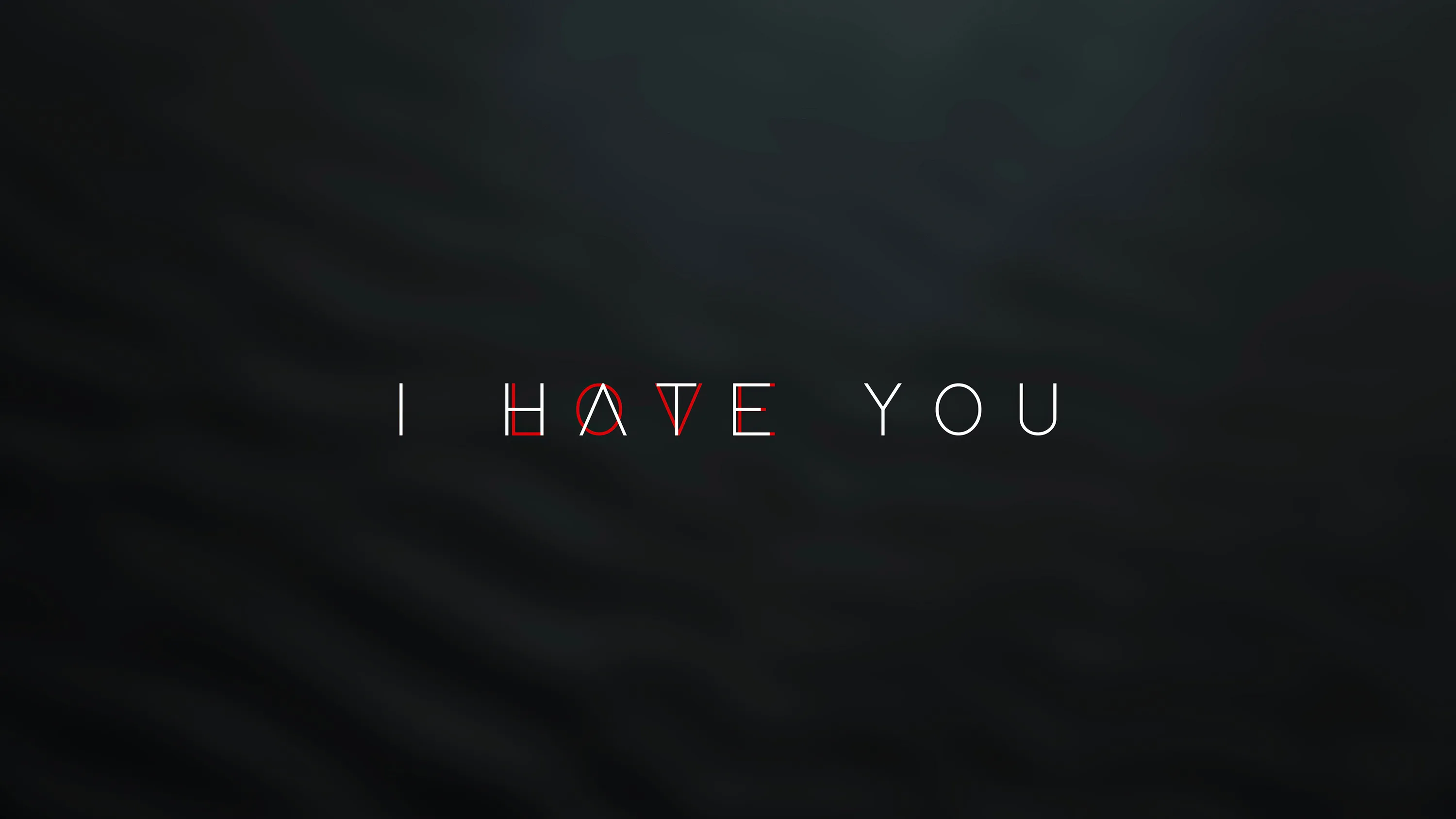 Thin spaced capitals read I hate you across a softly textured charcoal wall, only the middle word tinted red.