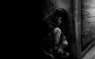 Boy Crouched Against a Wall HD Wallpaper