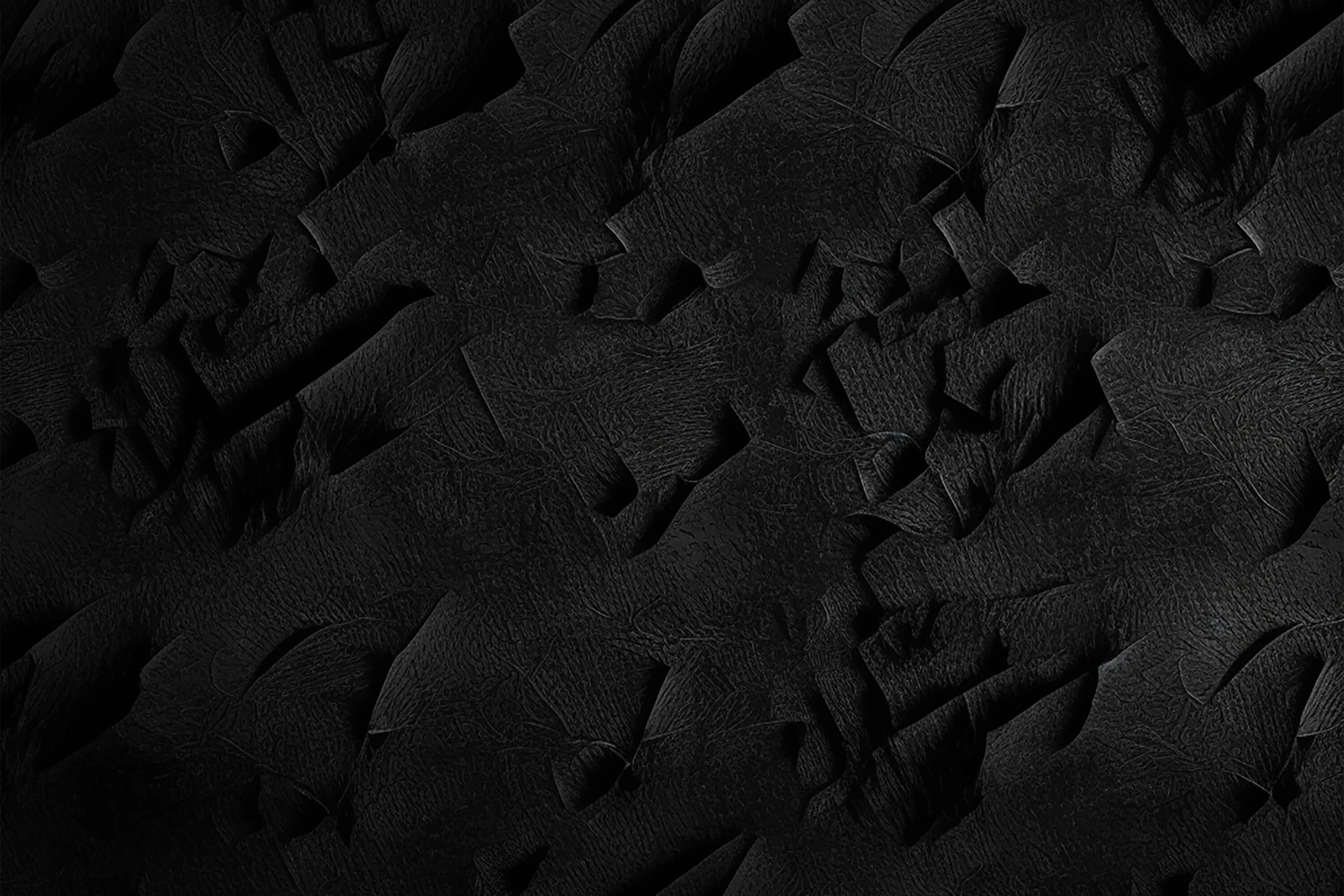 Ragged shards lift from a crumpled leather-like surface, each tear catching a sliver of light while the rest sinks into black.