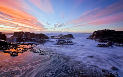 Swirling Foam Around Dark Rocks at Dawn HD Wallpaper