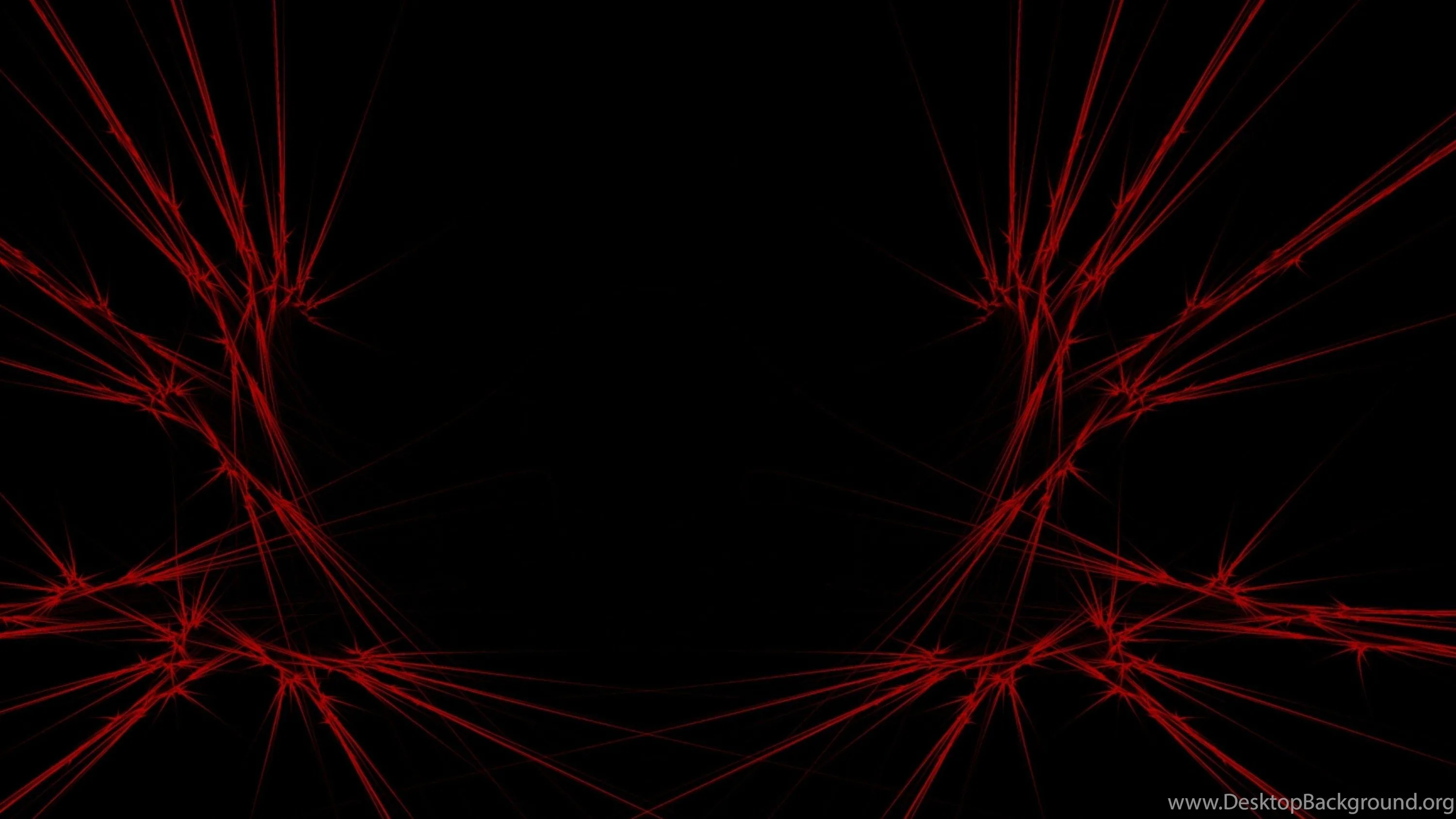 Spiky red filaments creep in from the left and right borders, the centre of the frame kept fully black.