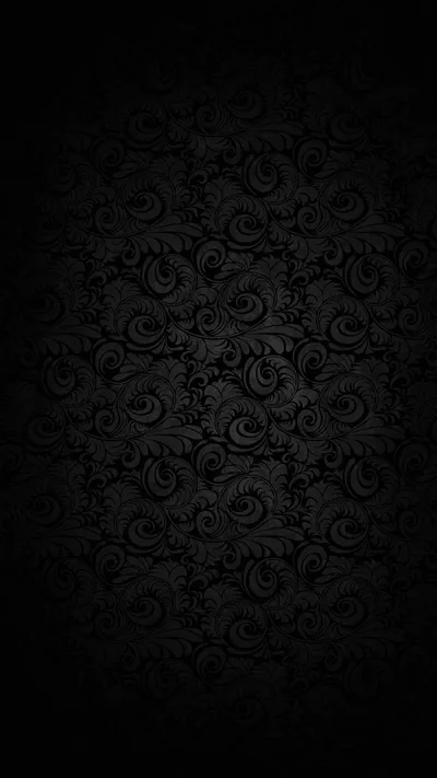 A tall panel of curling damask scrollwork sits in near-black, the relief just readable down the middle strip and lost along both sides.