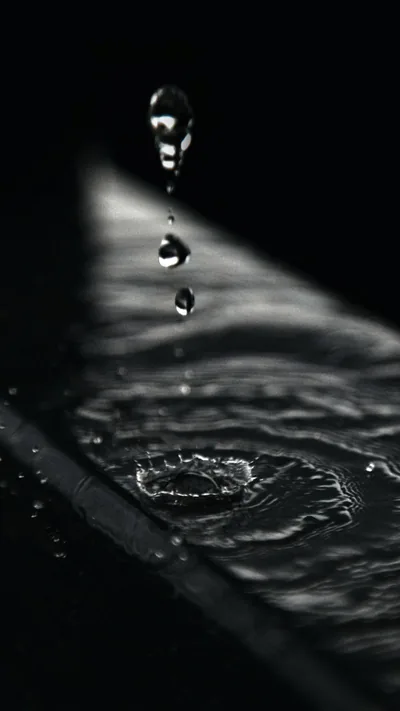 Water Drop Falling onto a Dark Surface HD Phone Wallpaper