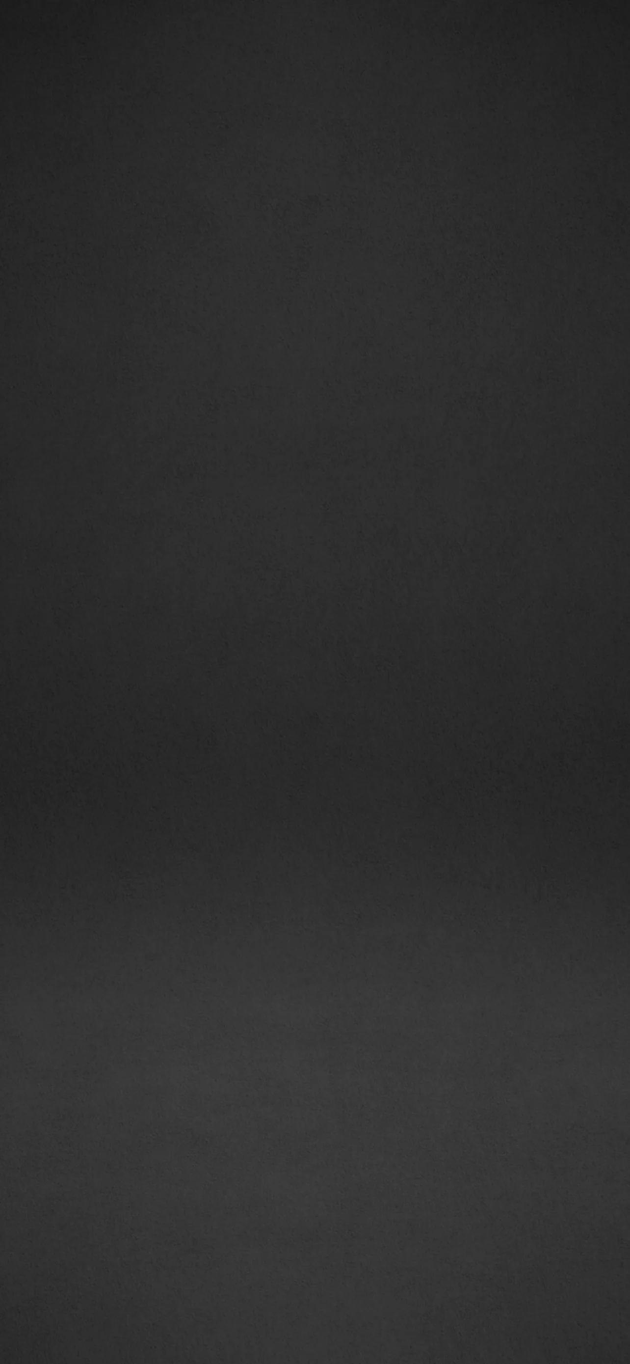 An even charcoal gradient that brightens slightly below centre, with no pattern anywhere, so icons and clock text stay readable across the whole screen.