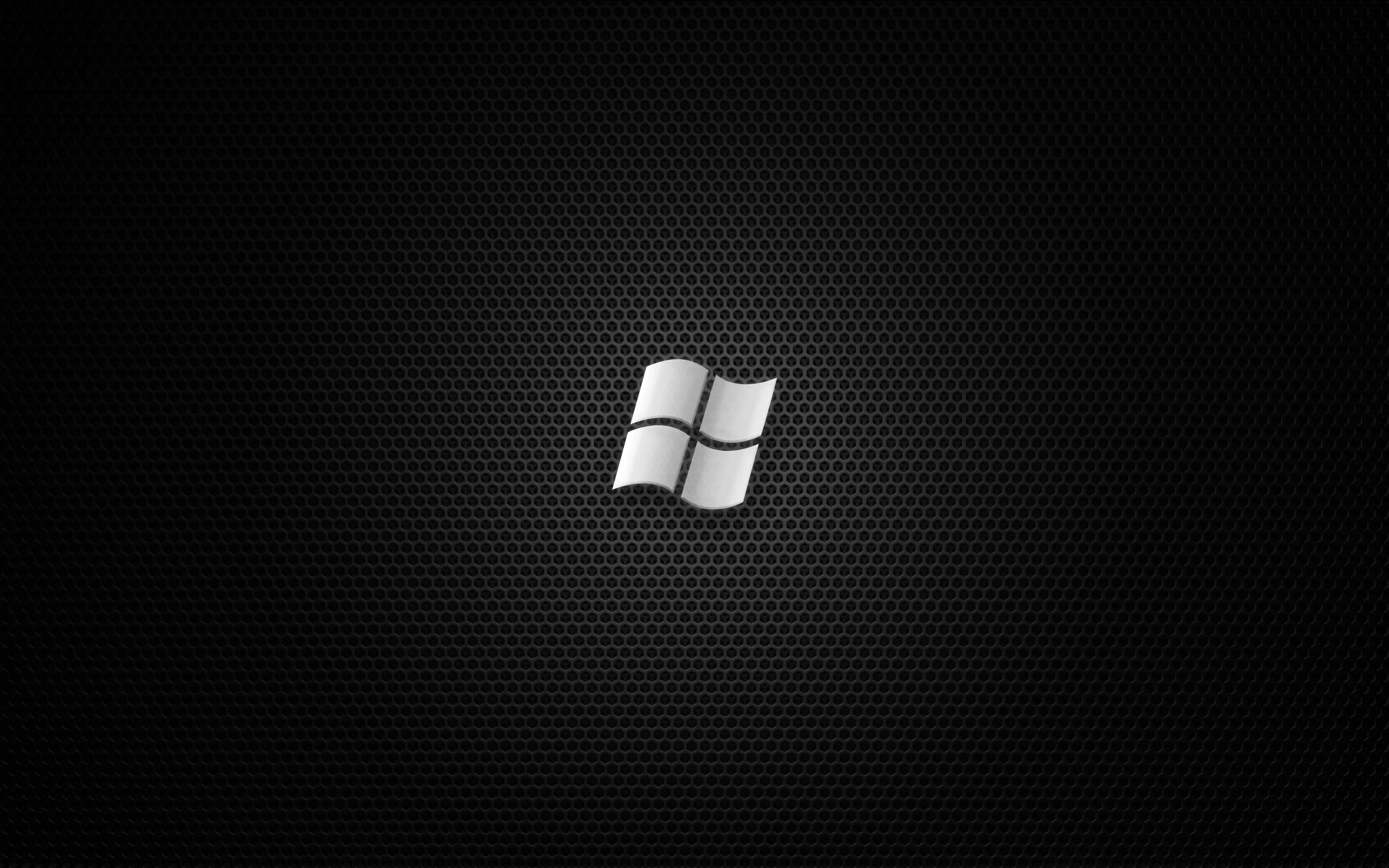 A metallic window mark sits at the centre of a fine honeycomb mesh, catching light along its top edge.