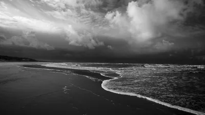 Storm Clouds Over an Empty Beach HD Wallpaper