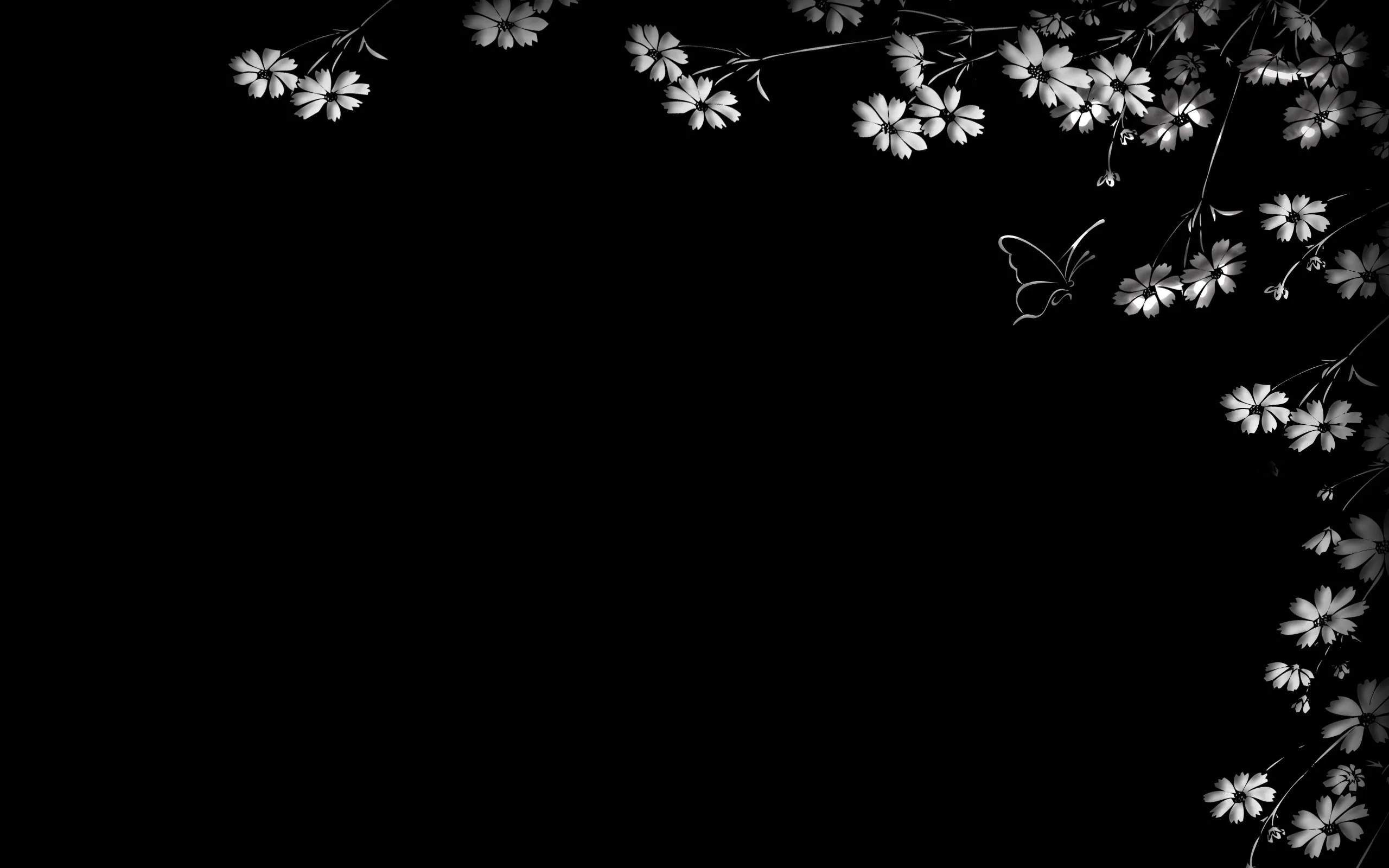 Small pale flowers and a butterfly branch in from the top right and lower right, the left half left completely black.