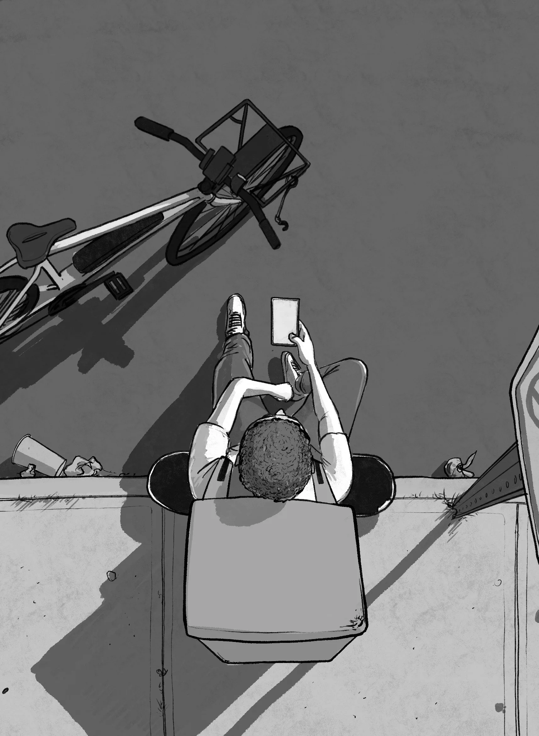 Looking straight down in greyscale at a boy sitting on a low wall reading, his bike thrown on the pavement casting a long shadow.