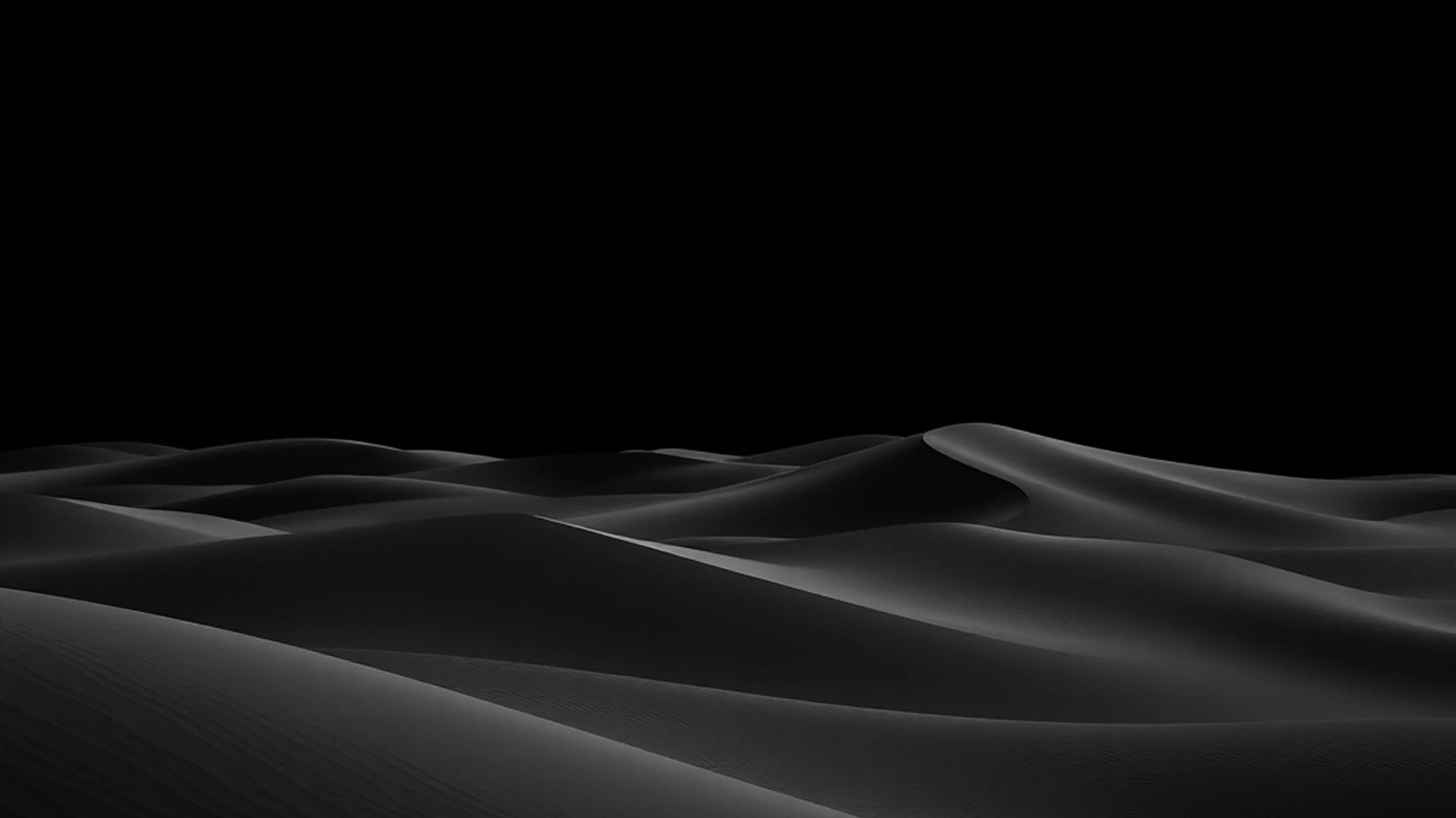 Ridges of dark sand roll across the lower half of the frame, lit from the left, the sky above them left completely black.