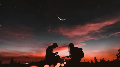 Sunset Silhouettes Under a Crescent Moon HD Wallpaper