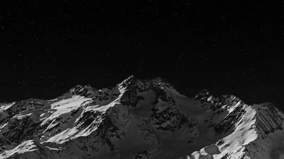 Snowy Peaks Under a Black Sky HD Wallpaper